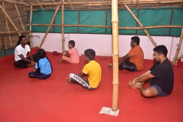 Children and adults in a yoga session